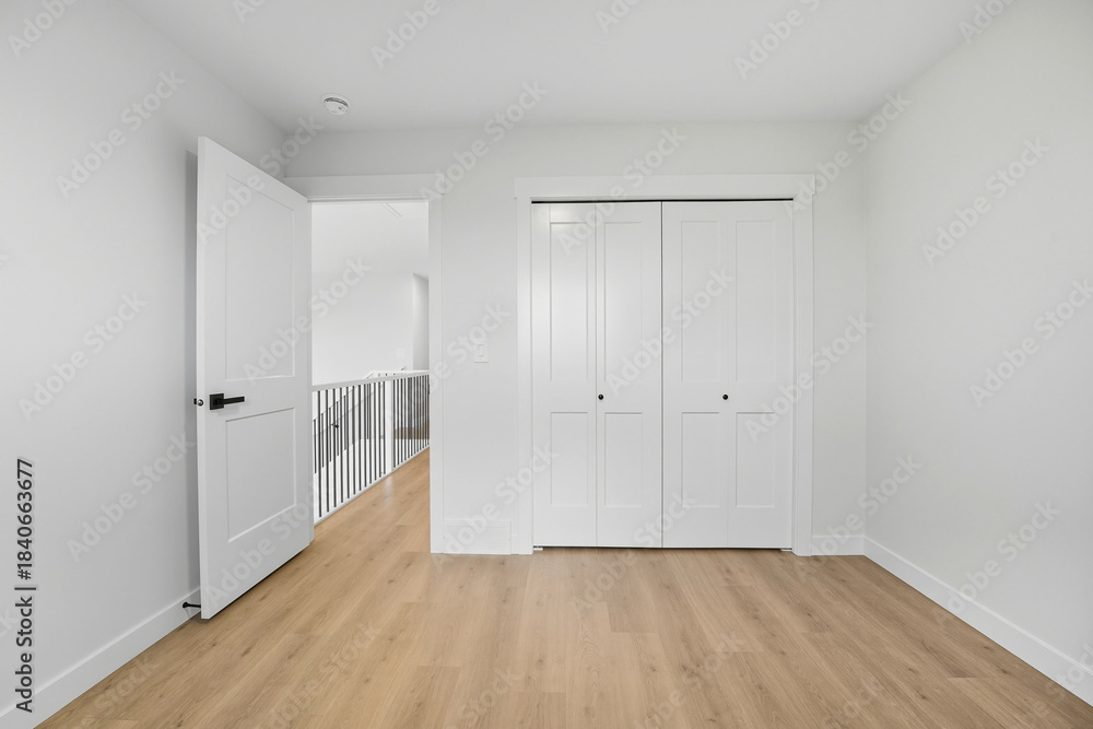 Obraz premium White bedroom with a white closet and a white door