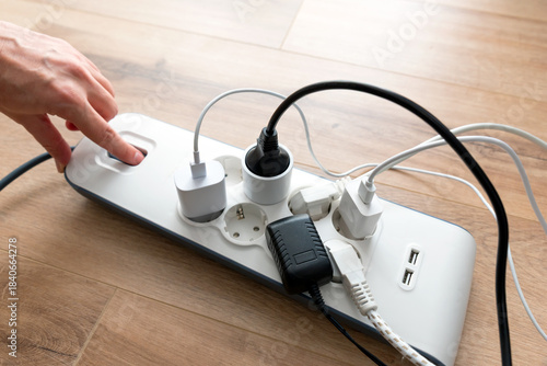 Person is plugging in a device to a power strip