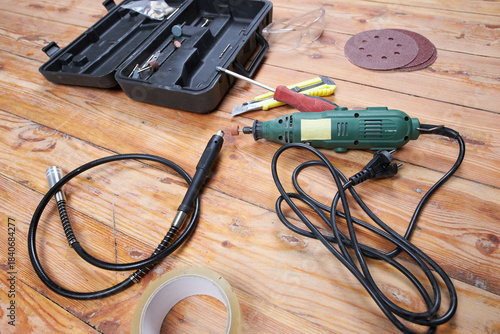 Working tools for repairs on a wooden floor.