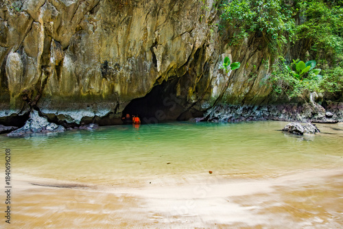 Tourists swimming into the mysterious Emerald Cave known as Tham Morakot, a hidden beach paradise accessible by an emerald lagoon on Ko Muk island in Trang, Thailand