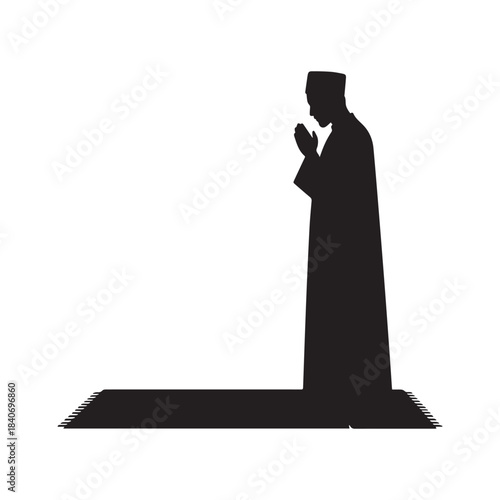 Black Silhouette of Muslim Man Standing and Praying on Mat in Traditional Dress. 