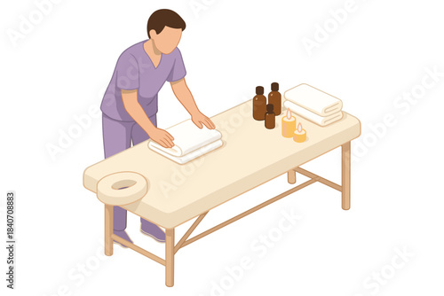 Young male preparing massage table with towels and oils in spa setting