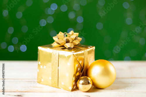 Christmas gift box on table against bokeh background