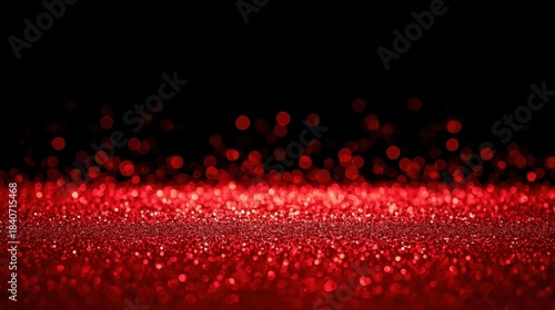 Intense, vibrant red glitter floor or surface sparkling brightly against a solid black background, creating a high-contrast, dramatic, and festive visual effect.