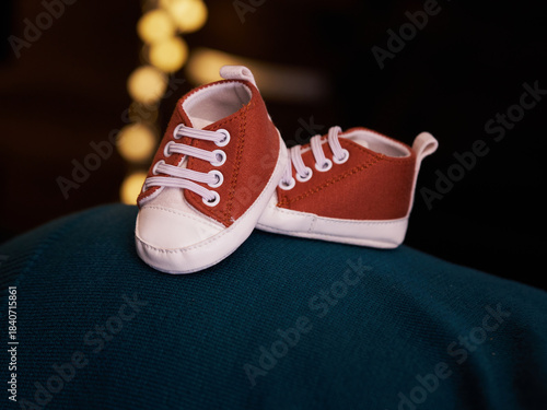 Orange baby shoes with bokeh background