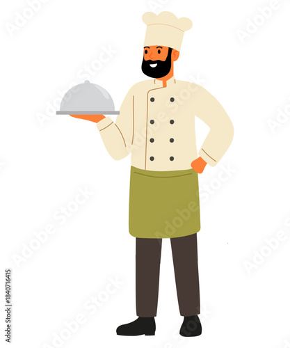 Chef. Brown hair wearing white chef hat, jacket and a green apron. Man smiling and holding silver platter with gray dome lid.