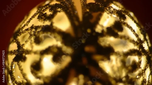 Glowing orb with intricate patterns, suggesting a decorated glass ball. Illuminated against a dark background