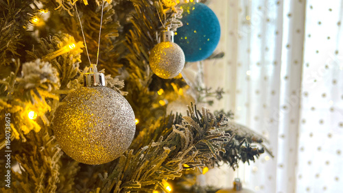 Golden sparkle Christmas tree decoration close up with shiny balls