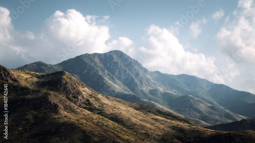 Tranquil panoramic view of rugged mountain range against cloudy sky