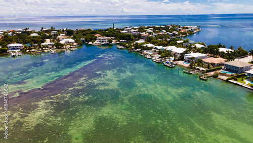 Drone view of Key West coastline with residential houses and boats