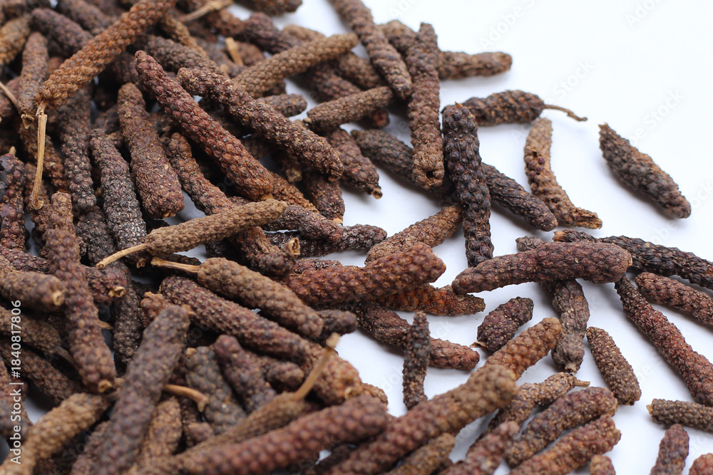 Fototapeta premium Long pepper (Piper longum), a spice used in traditional medicine and cooking, known for its pungent flavor.