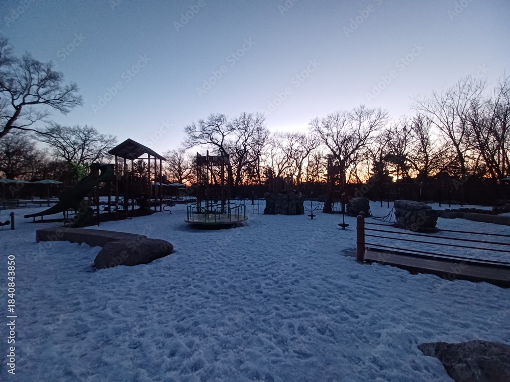 Obraz premium Orange playground structure covered with snow