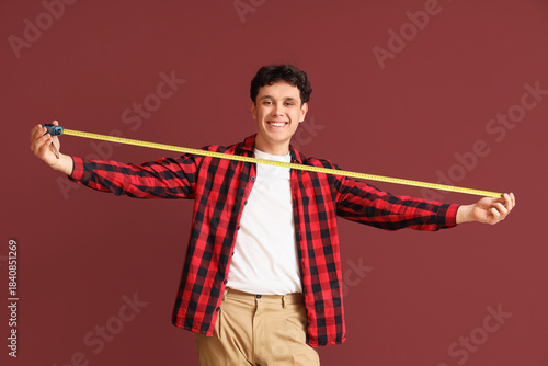 Young man with tape measure...