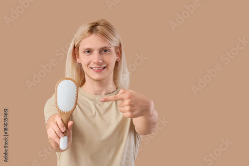 Young blonde man pointing a...