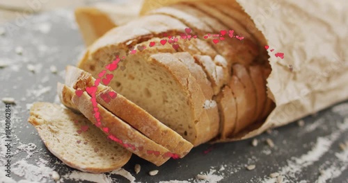 Heart particles entering lower edges, orbiting around rustic loaf, dispersing to highlight bread