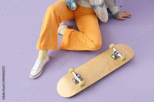 Young woman with skateboard...