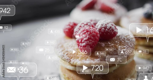 Bubbles entering frame, sugar dusting pancakes with 3 raspberries, counts rising showing engagement