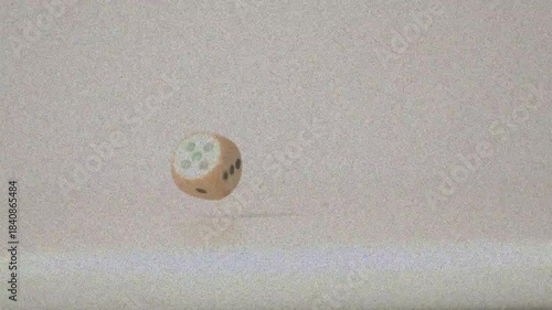 Wooden die launched by initial toss, tumbling and rotating downward, showing pip faces for study