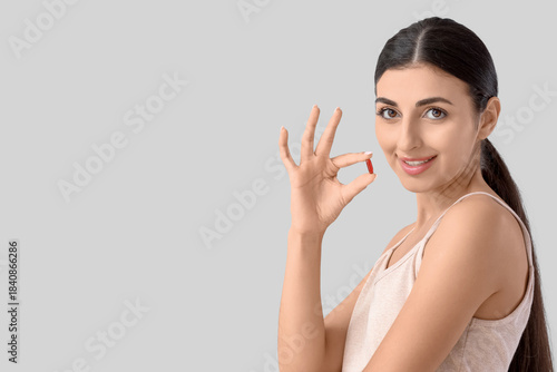Young woman with vitamin E ...