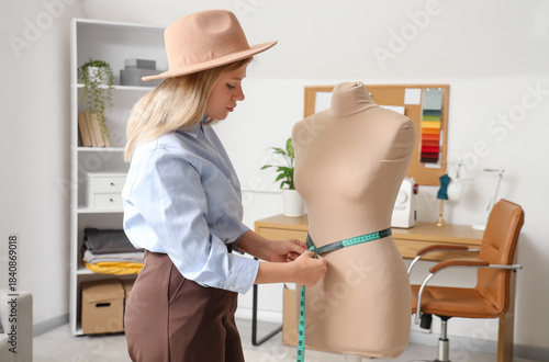 Female tailor measuring man...