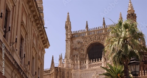 Morning sunny summer view of historic architectural features next to the downtown cathedral of Seville, Andalusia, Spain.