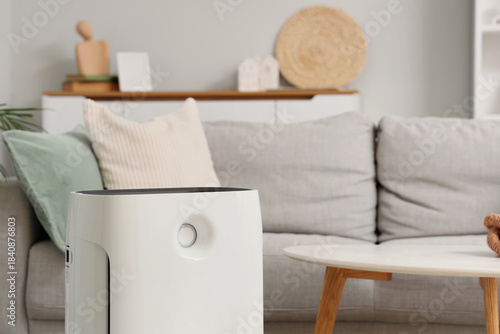 Modern air purifier on floo...