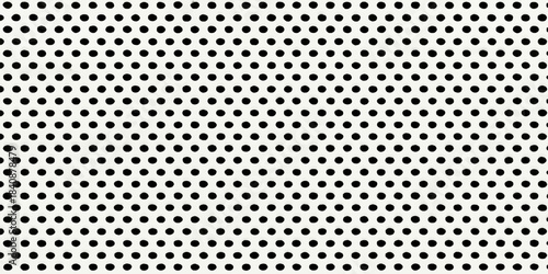 Abstract halftone background of black and white dots, providing a metallic steel texture for a modern carbon technology design pattern