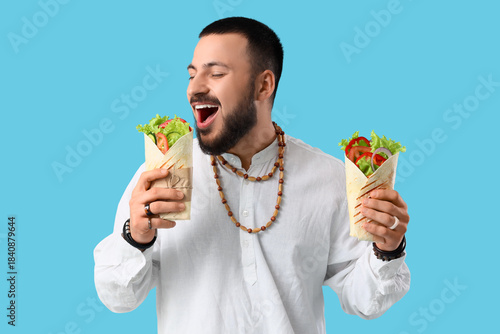 Young Muslim man with tasty...