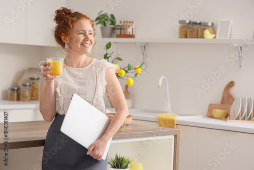 Young redhead woman with tu...