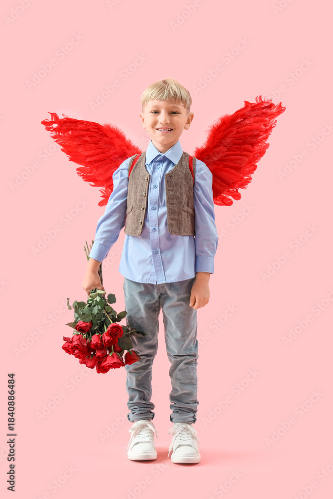 Naklejka premium Cute little happy boy in cupid wings with bouquet of beautiful roses on pink background. Valentine's Day celebration