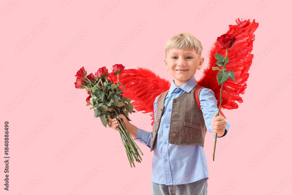 Naklejka premium Cute little happy boy in cupid wings with bouquet of beautiful roses on pink background. Valentine's Day celebration
