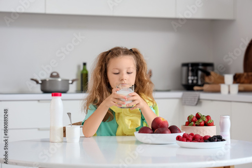 Cute little girl with glass...