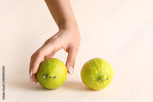 Female hand and fresh limes...