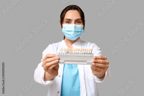 Young female dentist in mas...