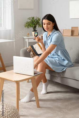 Young woman holding credit ...