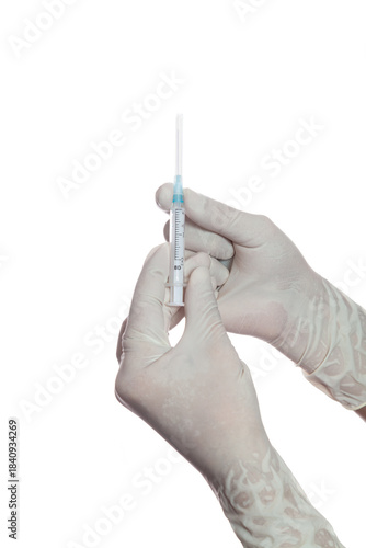 Hands in rubber gloves insert needle into disposable syringe