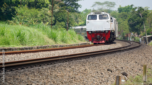 A fast-moving train glides smoothly along the railway tracks, showcasing power, motion, and precision in transportation