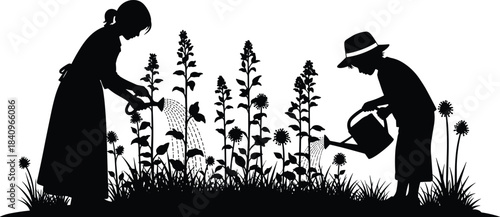 Silhouette of a mother and child bonding while happily watering tall blooming flowers in a lush garden border on a warm spring day