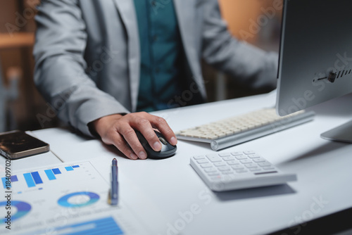 Business person working late using computer at office