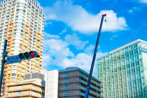 A cityscape of cranes at the under construction in the urban city in Tokyo