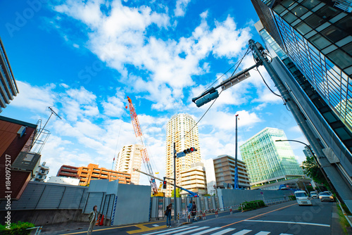A cityscape of cranes at the under construction in the urban city in Tokyo wide shot