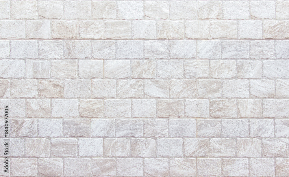 Naklejka premium Detail of modern cream brick wall background photo. White light brick wall texture background for stone tile block painted in beige light color wallpaper modern interior and exterior backdrop design.
