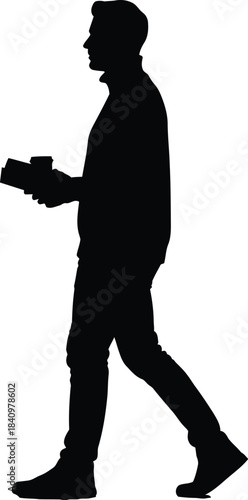 Silhouette of a man walking while holding a camera and a cup