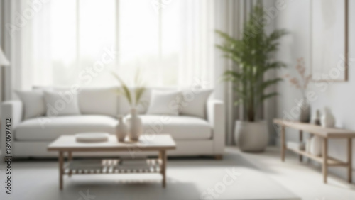 Blurred Soft-focus modern living room interior with a comfortable white sofa, elegant coffee table, and natural light, creating a serene and inviting contemporary home