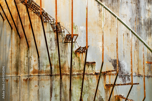 old rusted stairs on a storage tank
