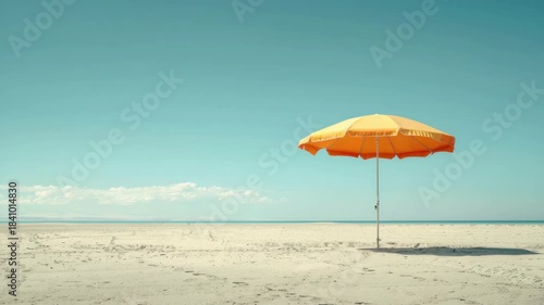 Single yellow beach umbrella on serene empty