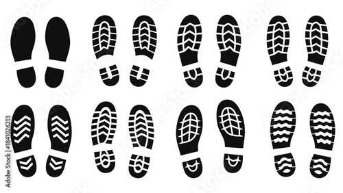Collection of black shoe soles and footprints arranged in neat rows