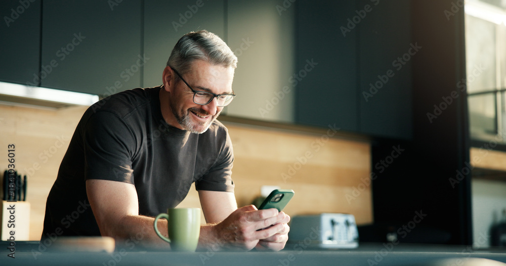 Fototapeta premium Happy man, scroll and typing in kitchen with phone, social media notification and text message update. Mature person, smile and browsing with tech in home for news feed, online communication or chat.