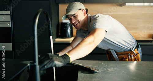 Faucet, maintenance and repair with plumber in kitchen of home for installing or testing water supply. Checking, plumbing fix and tap with man in apartment for inspection or renovation as contractor