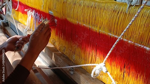 Handloom weaver in India working in her loom.